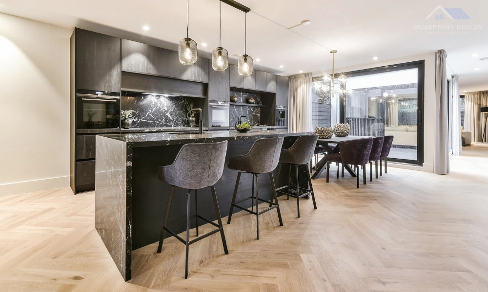 Contemporary kitchen with black marble island and open dining space